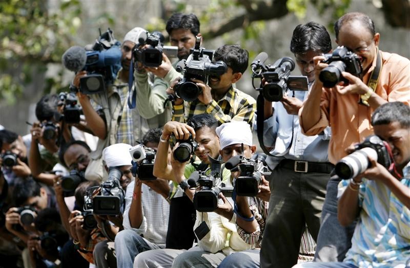 Photographers and video cameramen gather outside the special court in Mumbai May 18, 2007. The court on Friday commenced sentencing against the 100 people found guilty of involvement in the 1993 bombings in Mumbai which killed 257 people. REUTERS/Punit Paranjpe (INDIA)
