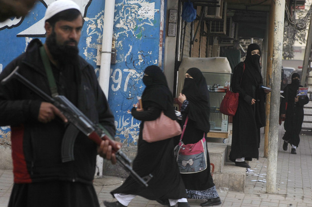 Security guards stand alert around schools and colleges following an attack on Bacha Khan University, in Peshawar, Pakistan, Thursday, Jan. 21, 2016. Pakistanis buried their dead and observed a day of nationwide mourning Thursday following the brazen attack by Islamic militants who stormed a northwestern university the previous day, gunning down students and teachers and spreading terror before the four gunmen were slain by the military. (AP Photo/Mohammad Sajjad)